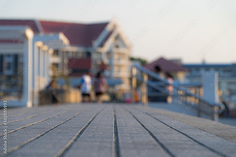Fototapeta premium Close up view and copy space of concrete floor. The field was divided into equal in the multipurpose yard of public places. Blurry building background during the evening.