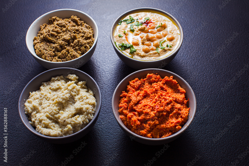 Bowls with delicious hummus and veggie spreads Bowls with delicious hummus and veggie spreads