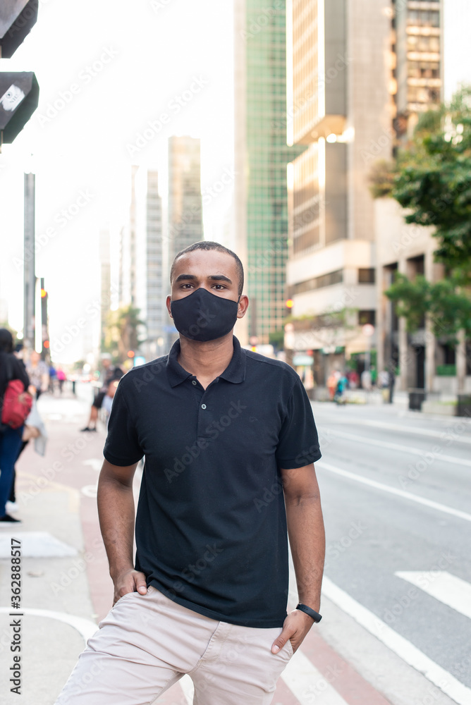 young man with protective mask against corona virus on the street young man with protective mask against corona virus on the street