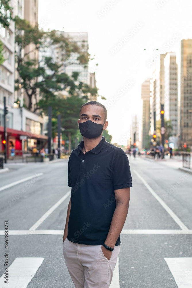 young man with protective mask against corona virus on the street
