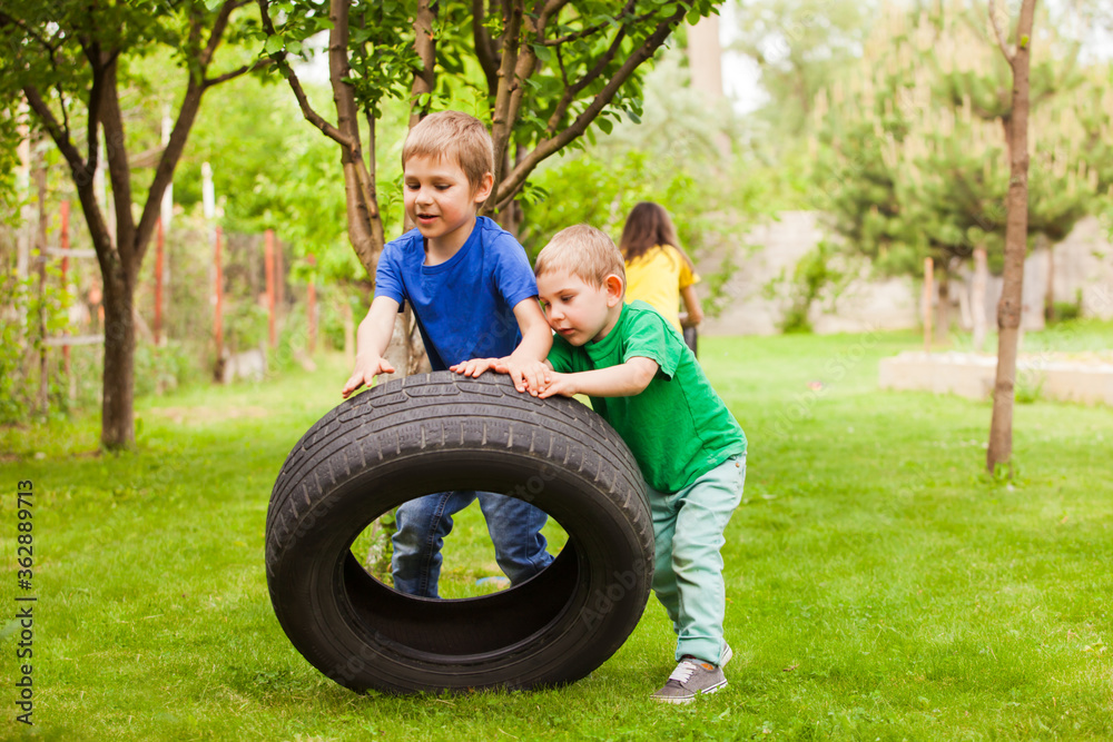 © oksix - The little boys develop physical strength using improvised things