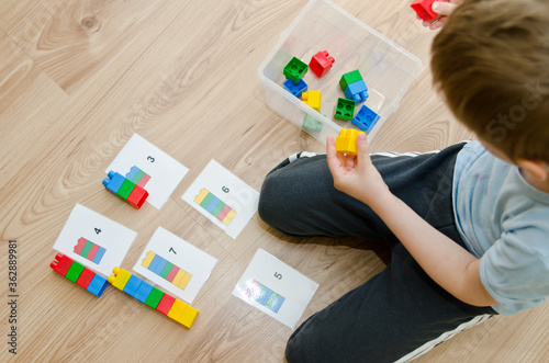 Child learning to count with blocks.