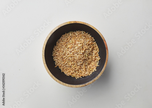Top view shot of brown rice on white background.