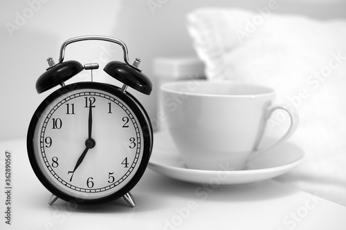 Image of coffee cup and alarm clock. 