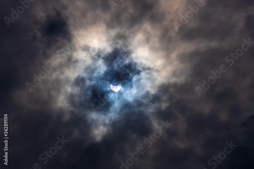 Surreal Dramatic Solar Eclipse Covered By Clouds. Natural Phenomenon.