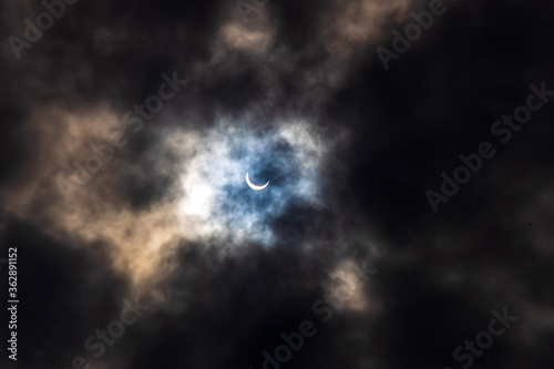 Surreal Dramatic Solar Eclipse Covered By Clouds. Natural Phenomenon.