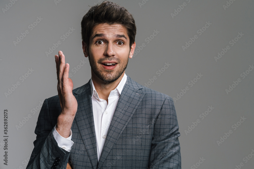 Photo of unshaven excited businessman expressing surprise on camera Photo of unshaven excited businessman expressing surprise on camera