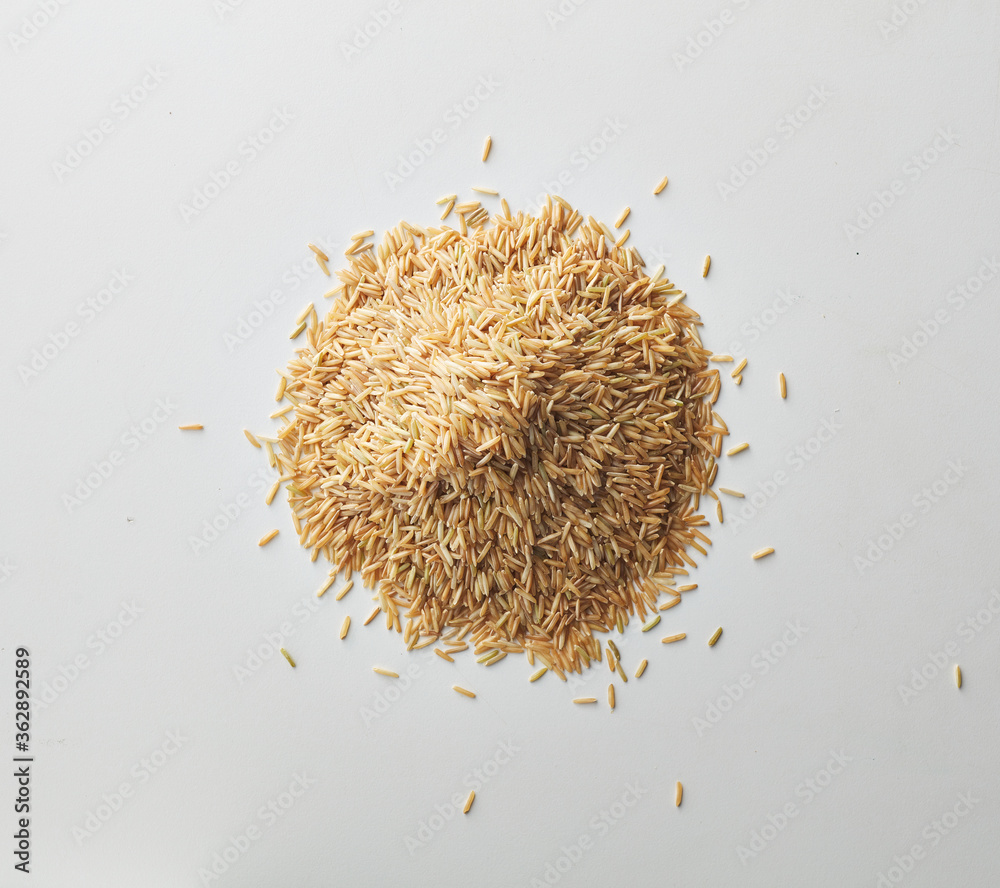 Top view shot of brown rice on white background. Top view shot of brown rice on white background.