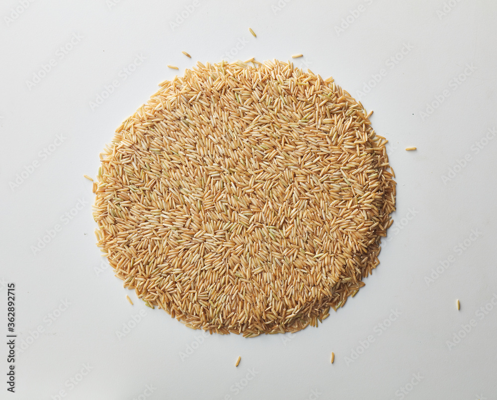 Top view shot of brown rice on white background. Top view shot of brown rice on white background.