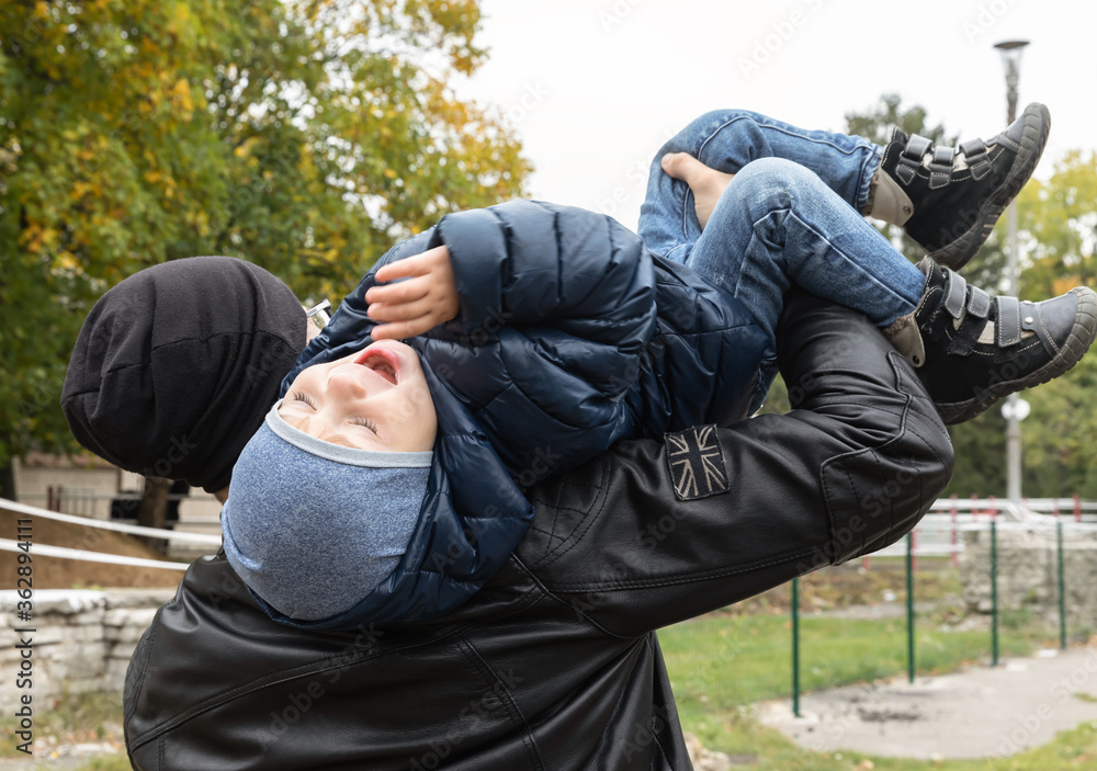 father carries son on his shoulder father carries son on his shoulder