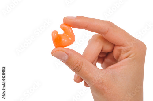 Isolated on white earplug in female hand. Personally molded earplugs close-up. Part of the set