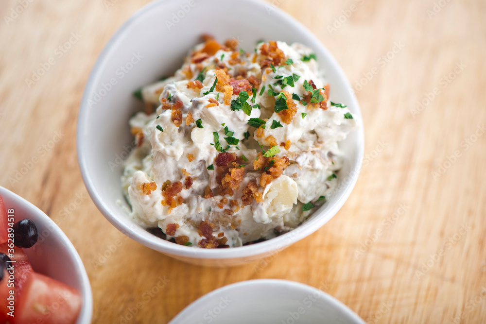 Steakhouse side dishes. Asparagus, salad, tomatoes, mashed potatoes, red onions, cream cauliflower, pickled peppers, seasoned meats served in cast iron skillet. Traditional appetizer items.