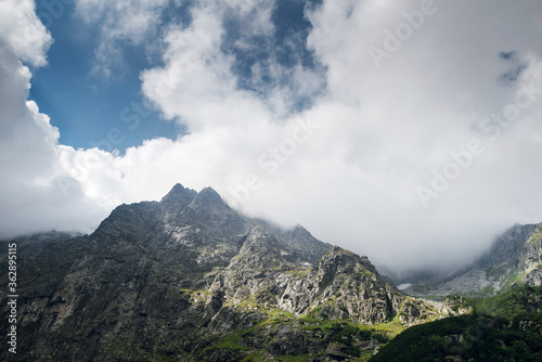 Scenic view of beautiful rocky mountain hills and peaks covered by clouds. Marine Eye lake, High Tatras, Zakopane, Poland