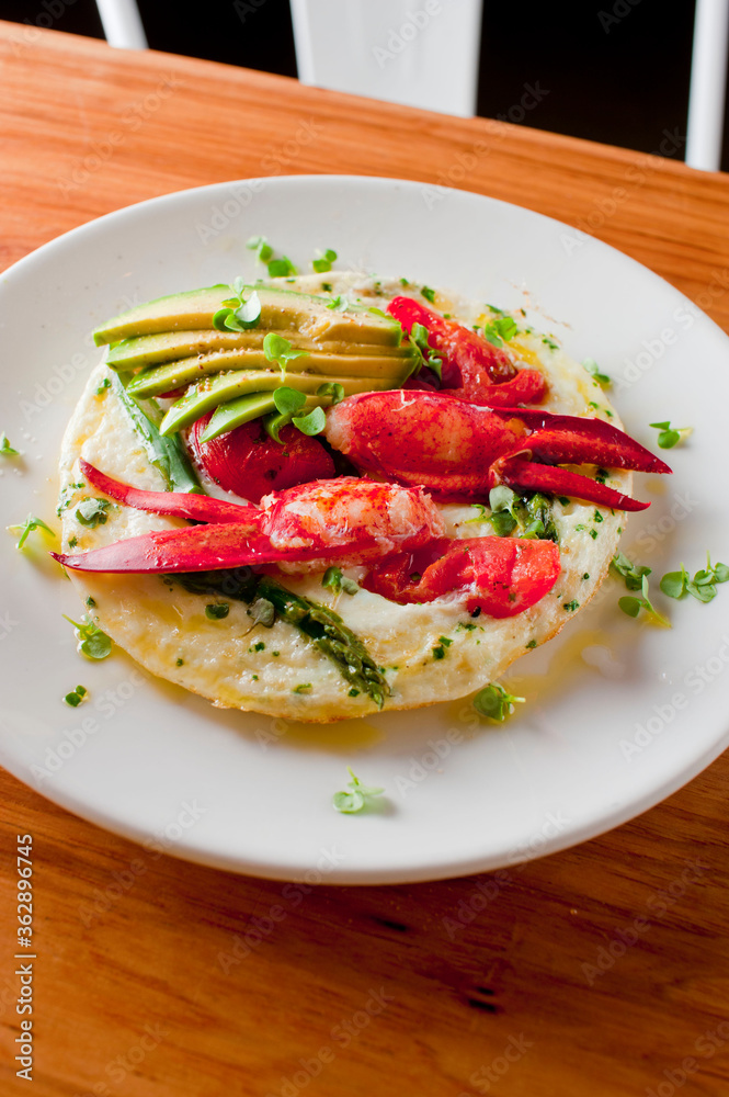 Frittata or omelette lobster avocado. Egg-based Italian dish w/ scrambled eggs, enriched with additional ingredients. classic seafood restaurant brunch/breakfast menu item. Maine lobster frittata. Frittata or omelette lobster avocado. Egg-based Italian dish w/ scrambled eggs, enriched with additional ingredients. classic seafood restaurant brunch/breakfast menu item. Maine lobster frittata.
