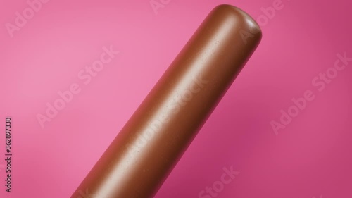 Brown chocolate Popsicle ice cream on a colorful pink background. Camera slide. Refreshing summer sweet. Realistic 3D animation.