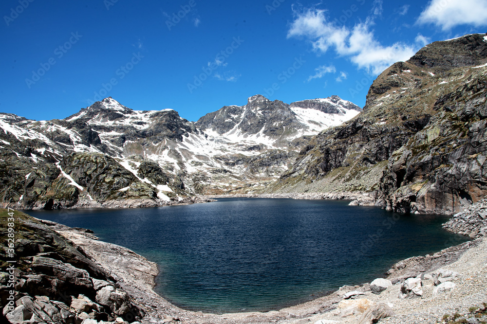 Mountain Lake  Alps Italy, with snow peak in the background