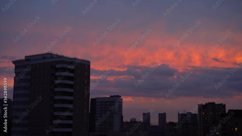 Beautiful Sunset Over The City, Scarlet Color. City Silhouette Under The Clouds and Beautiful Sky. Timelamps. Beautiful Sunset Over The City, Scarlet Color. City Silhouette Under The Clouds and Beautiful Sky. Timelamps.