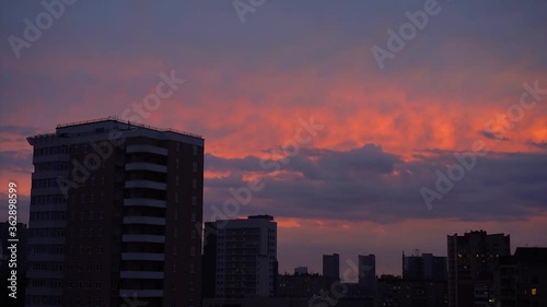 Beautiful Sunset Over The City, Scarlet Color. City Silhouette Under The Clouds and Beautiful Sky. Timelamps. photo