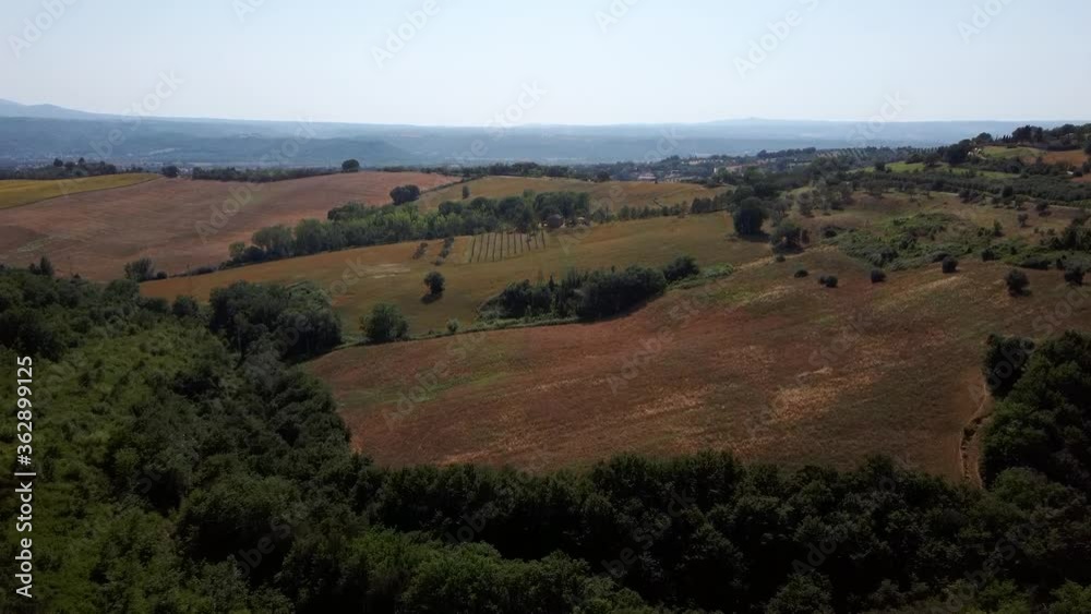 Aerial view of the Umbrian countryside with olive groves, cultivated fields and the forest in the hills Aerial view of the Umbrian countryside with olive groves, cultivated fields and the forest in the hills