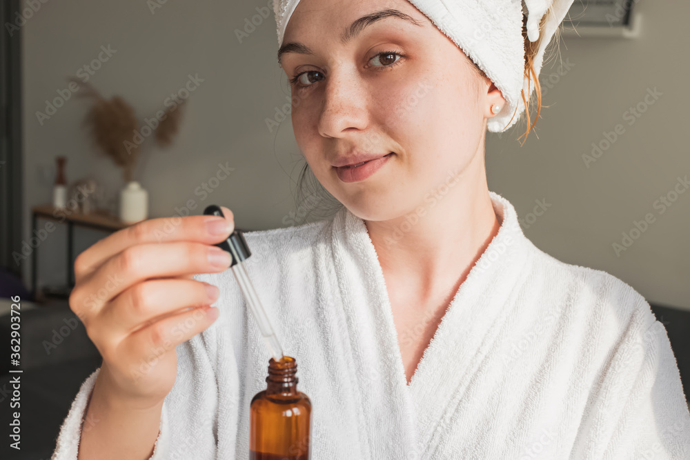 Fototapeta premium Young woman going to apply skincare product