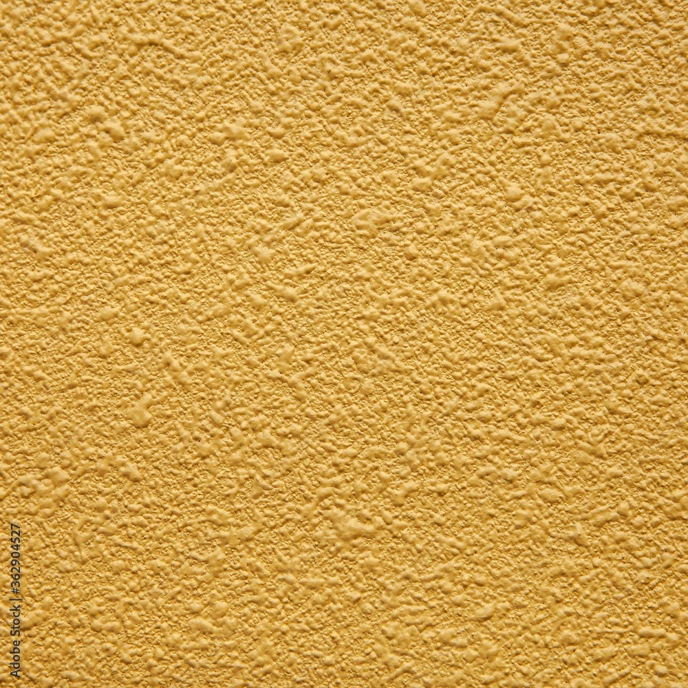 Yellow painted cement wall texture and seamless background