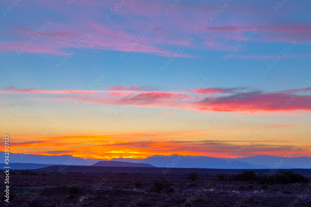 Pink and yellow colored clouds after sunset in the Karoo