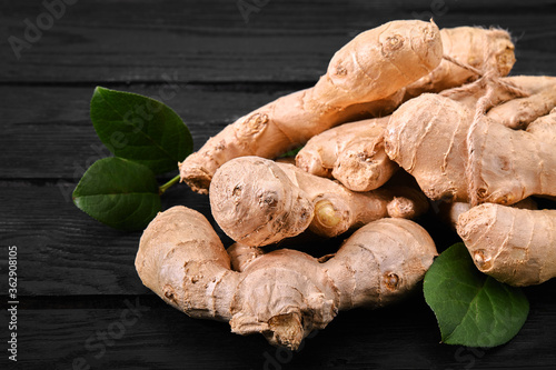 Fresh ginger root on stone background. Vitamins. Top view. Free space for your text.