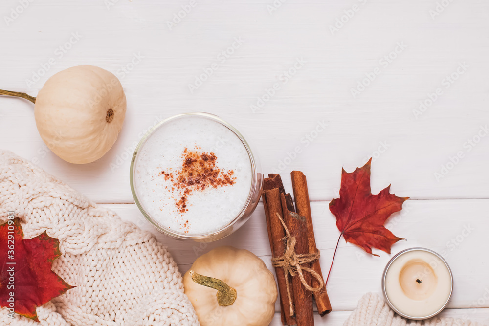 Cup of coffee with milk and cinnamon, autumn leaves and pumpkins Cup of coffee with milk and cinnamon, autumn leaves and pumpkins