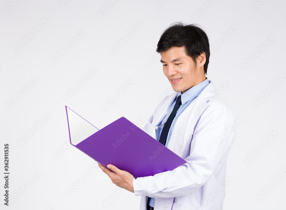 Asian male doctor standing and holds a purple file. Asian male doctor standing and holds a purple file.