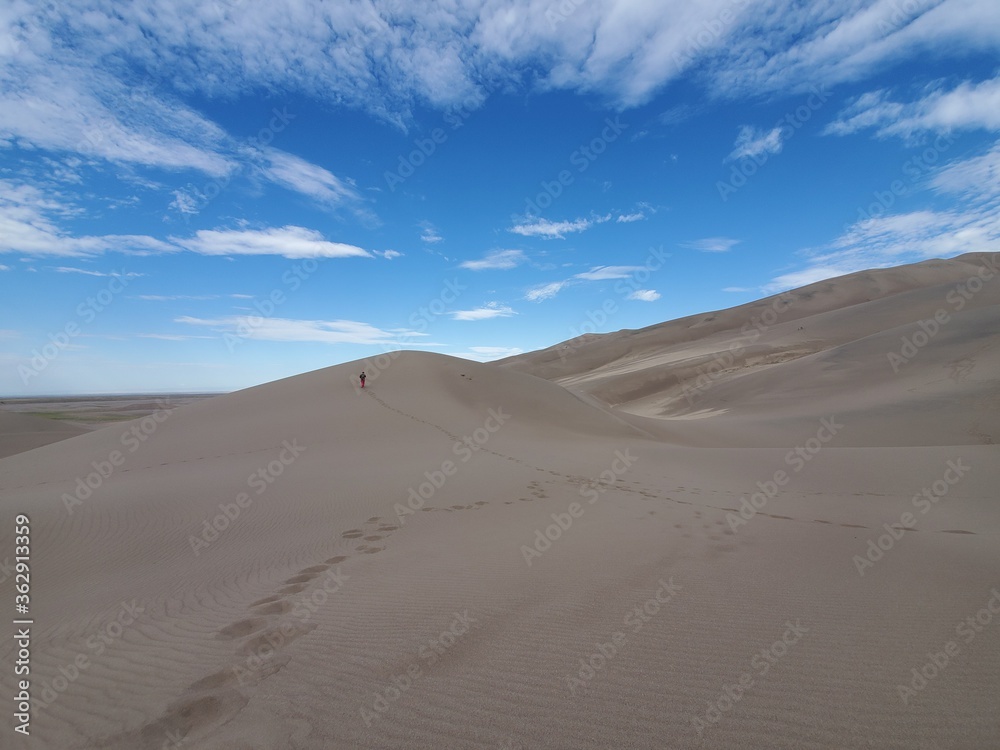 Man on a sand dune from a distance