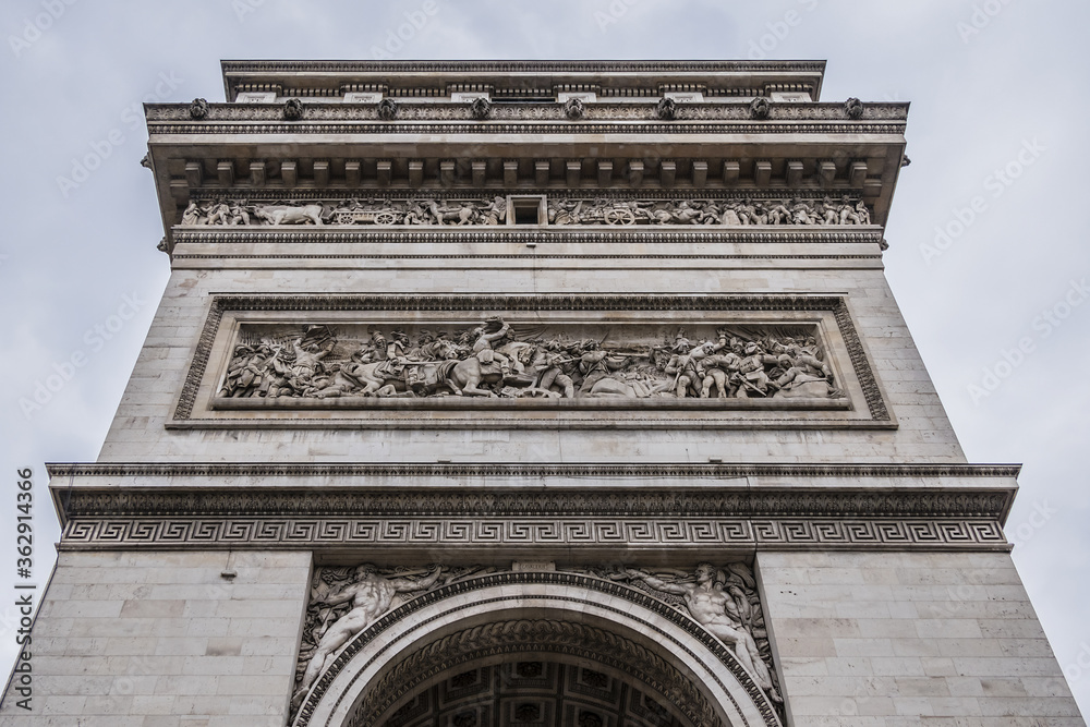 Architectural fragment of Arc de Triomphe. Arc de Triomphe de l'Etoile on Charles de Gaulle Place is one of the most famous monuments in Paris. France.
