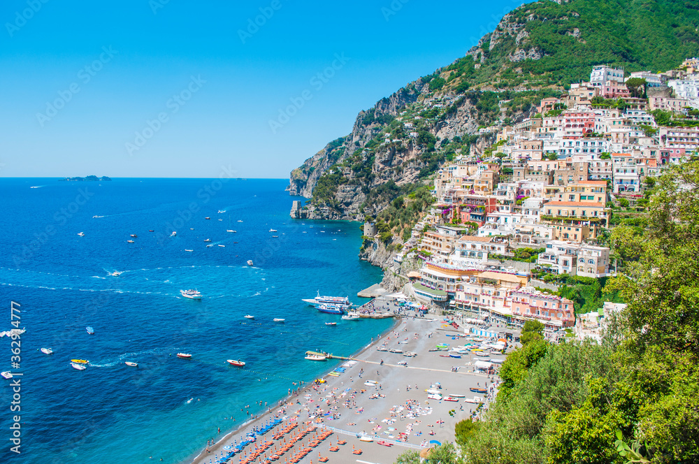 View town of Positano in Italy. Amalfi coast on the mountain. Bella italia. Boats on the sea. Umbrellas on the beach. 