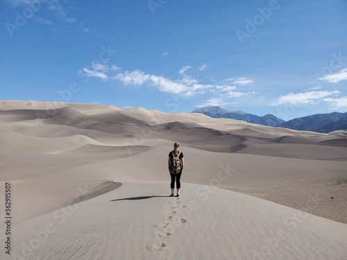 Girl looking over sand dunes