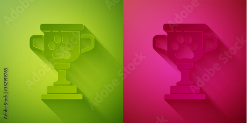 Paper cut Pet award symbol icon isolated on green and pink background. Medal with dog footprint as pets exhibition winner concept. Paper art style. Vector.