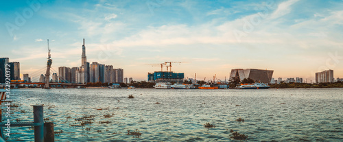 skyline with landmark 81 skyscraper, a new cable-stayed bridge is building connecting Thu Thiem peninsula and District 1 across the Saigon River.