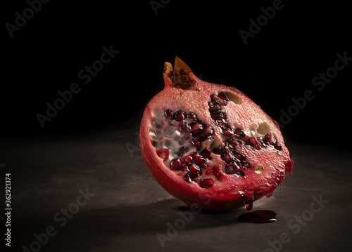 Pomegranate isolated on dark background. Studio shot photo