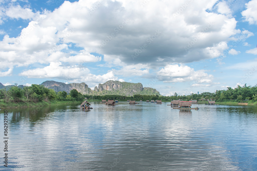 Rafting has many arches of houses in the river, mountains in the background Rafting has many arches of houses in the river, mountains in the background