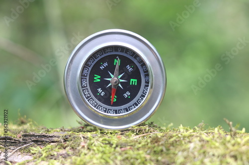 round compass on natural background as symbol of tourism