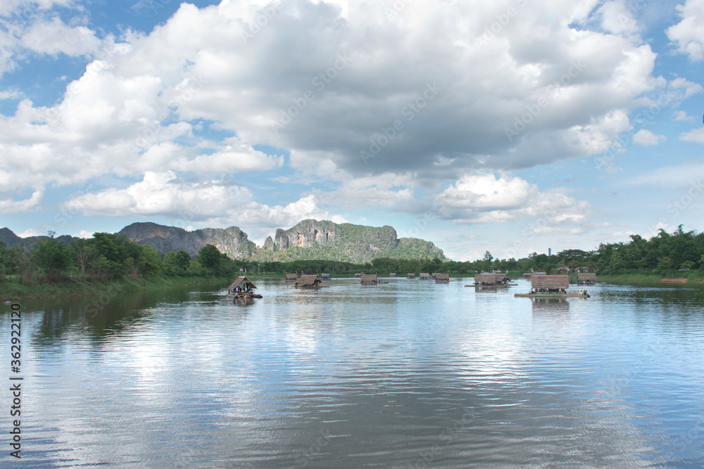 Rafting has many arches of houses in the river, mountains in the background Rafting has many arches of houses in the river, mountains in the background