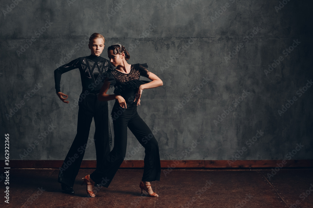 Young couple dancing in ballroom dance Paso doble.