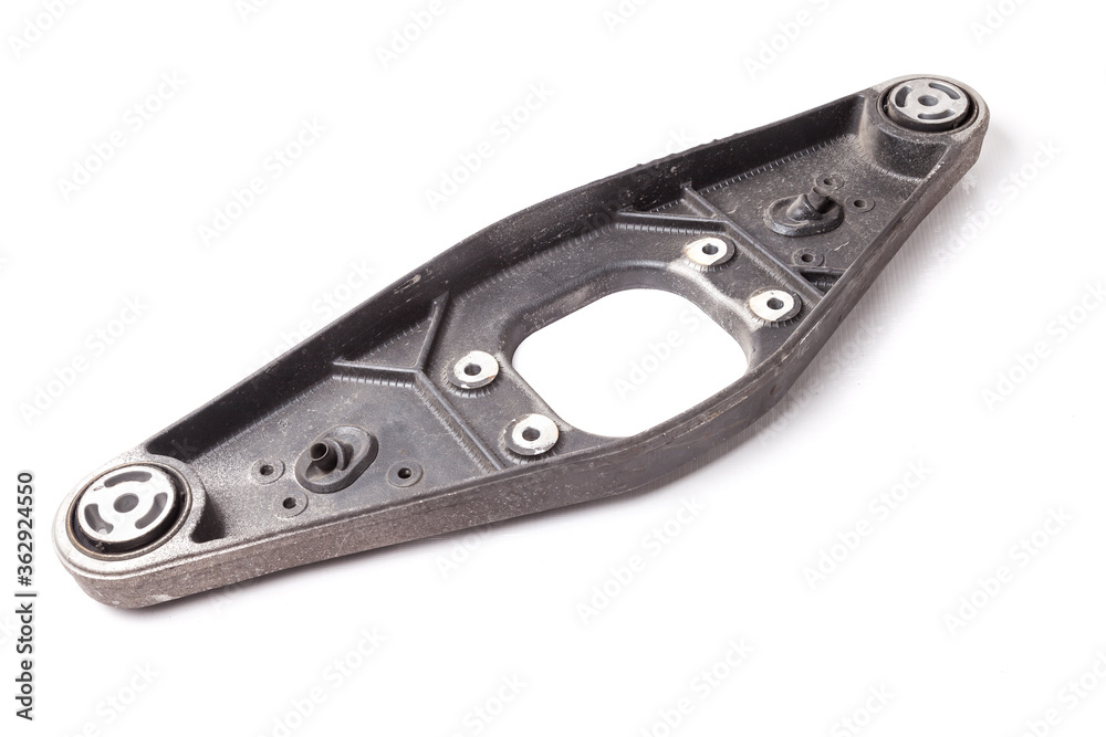 The back of the metal spare part is the transmission support for replacement during car repair on a white isolated background in a car service or for sale at an auto-parsing. The back of the metal spare part is the transmission support for replacement during car repair on a white isolated background in a car service or for sale at an auto-parsing.