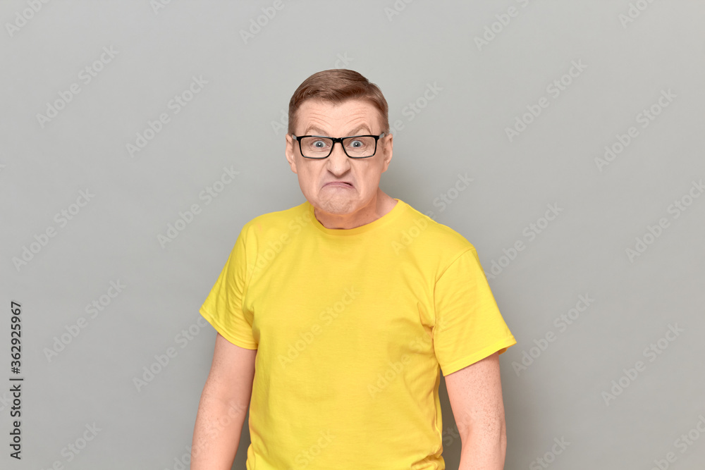 Obraz premium Portrait of angry irritated man with glasses grimacing from anger