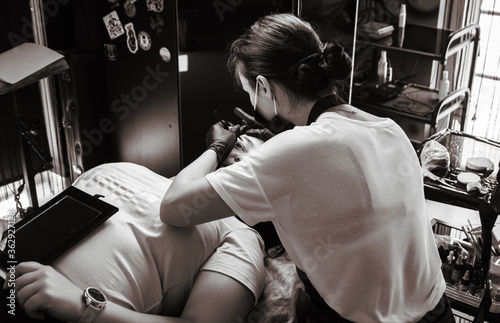 Girl artist paints an eyebrow tattoo. The process of tattooing. Permanent makeup