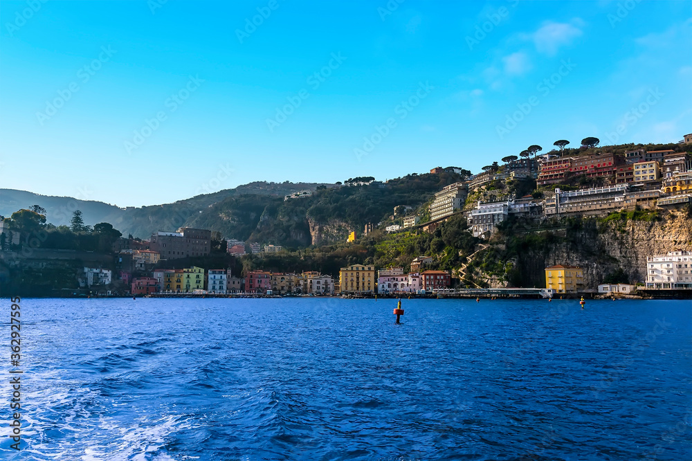 A panorama view looking towards the shore past the harbour wall of the marina Piccola, Sorrento, Italy from a boat heading to Capri A panorama view looking towards the shore past the harbour wall of the marina Piccola, Sorrento, Italy from a boat heading to Capri