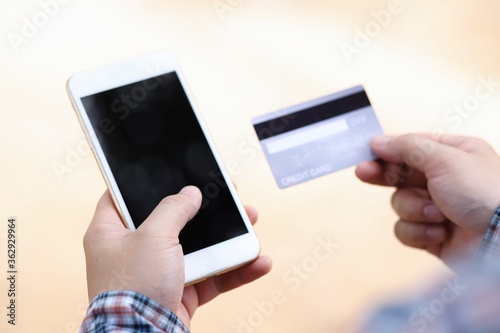 hands holding credit card and smart phone for online shopping.