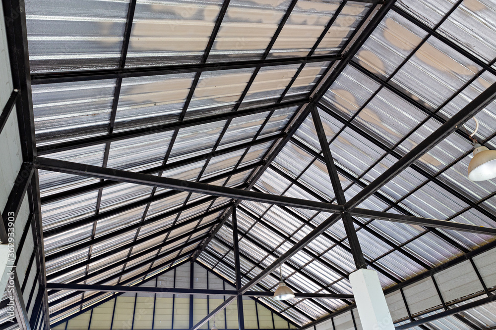 Steel roof structure. Moonlight bulb. Steel structure with roof tiles. Architectural structure of roof. Large roof layout used for industrial plants.