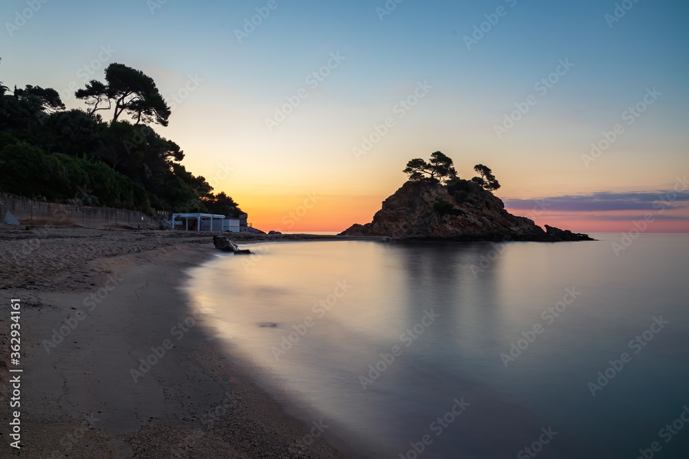 Long exposure view of the Cap Roig point sunrise and the beach of the same name. Catalonia, Spain