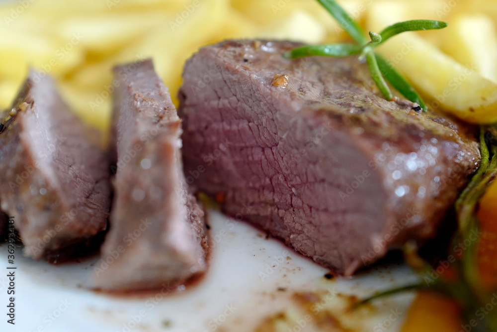 ready to eat - roasted venison from the chamois buck with vegetables and french fries on a white plate ready to eat - roasted venison from the chamois buck with vegetables and french fries on a white plate
