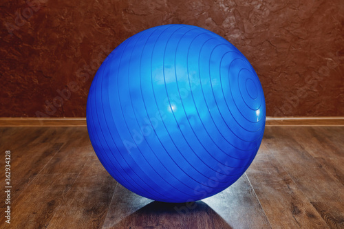 Blue rubber fitness ball in the gym.