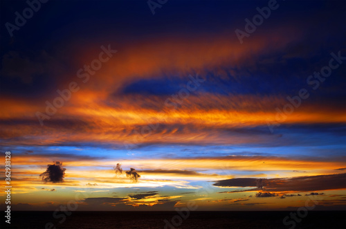 Dramatic sunset cloudy sky with picturesque clouds lit by warm sunset sunlight, natural sunset sky landscape view,natural sunset sky background, colorful sunset sky with dramatic sky clouds lit by eve © Rechitan Sorin